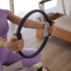 a woman sitting on the floor holding a steering wheel